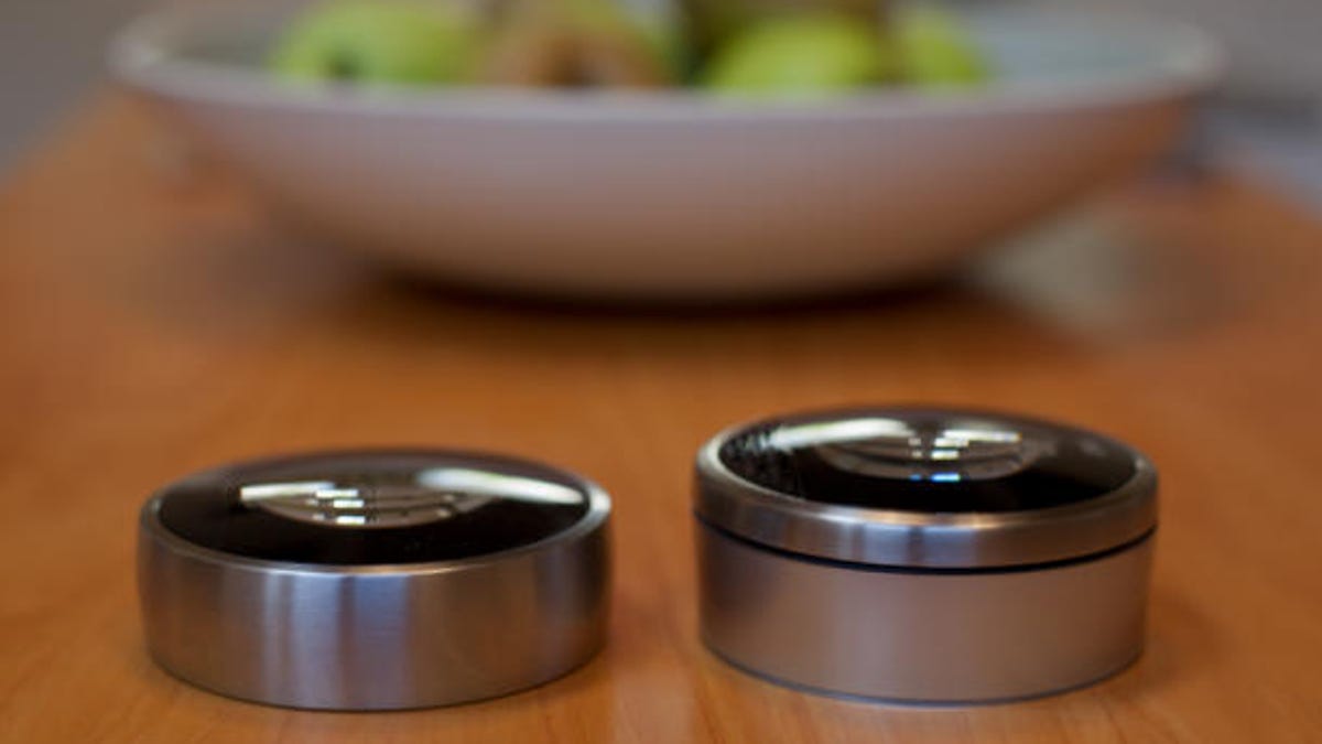 A look at the second-generation, slimmer Nest Learning Thermostat next to its predecessor.