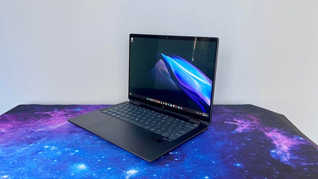 HP Spectre x360 14 Intel Core Ultra laptop at an angle against a gray wall