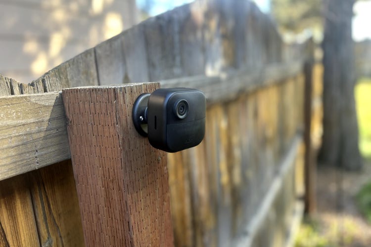 The Blink Outdoor 4 camera connected to a wooden fence post.