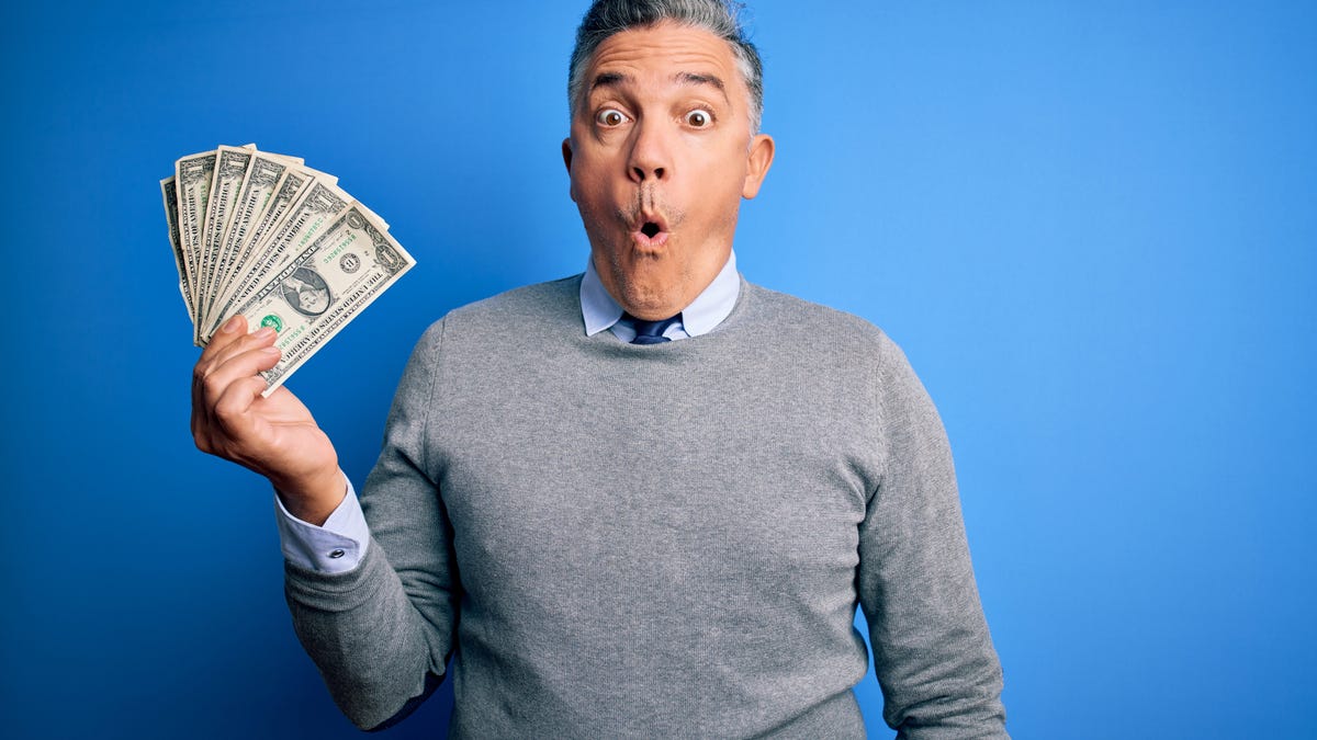 Man holding wad of cash