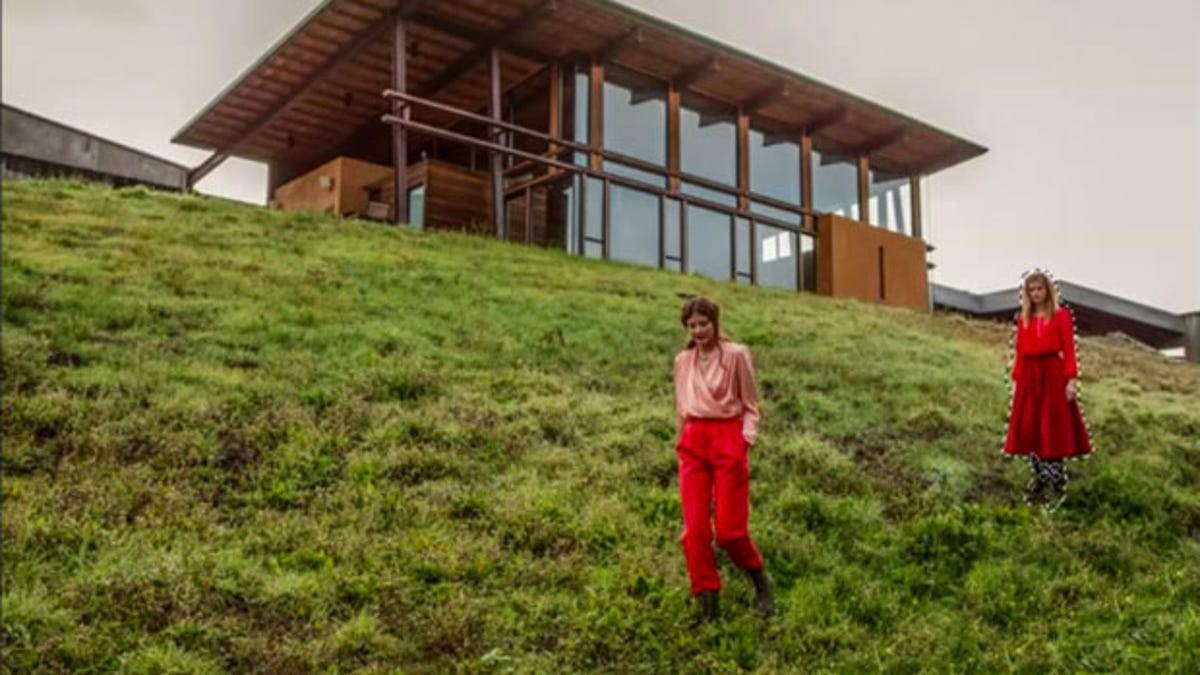 Photoshop CS6's content-aware move is shown here to move a woman in red.