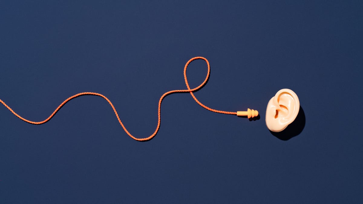 A cord twisted and pointed at a loose ear against a blue background