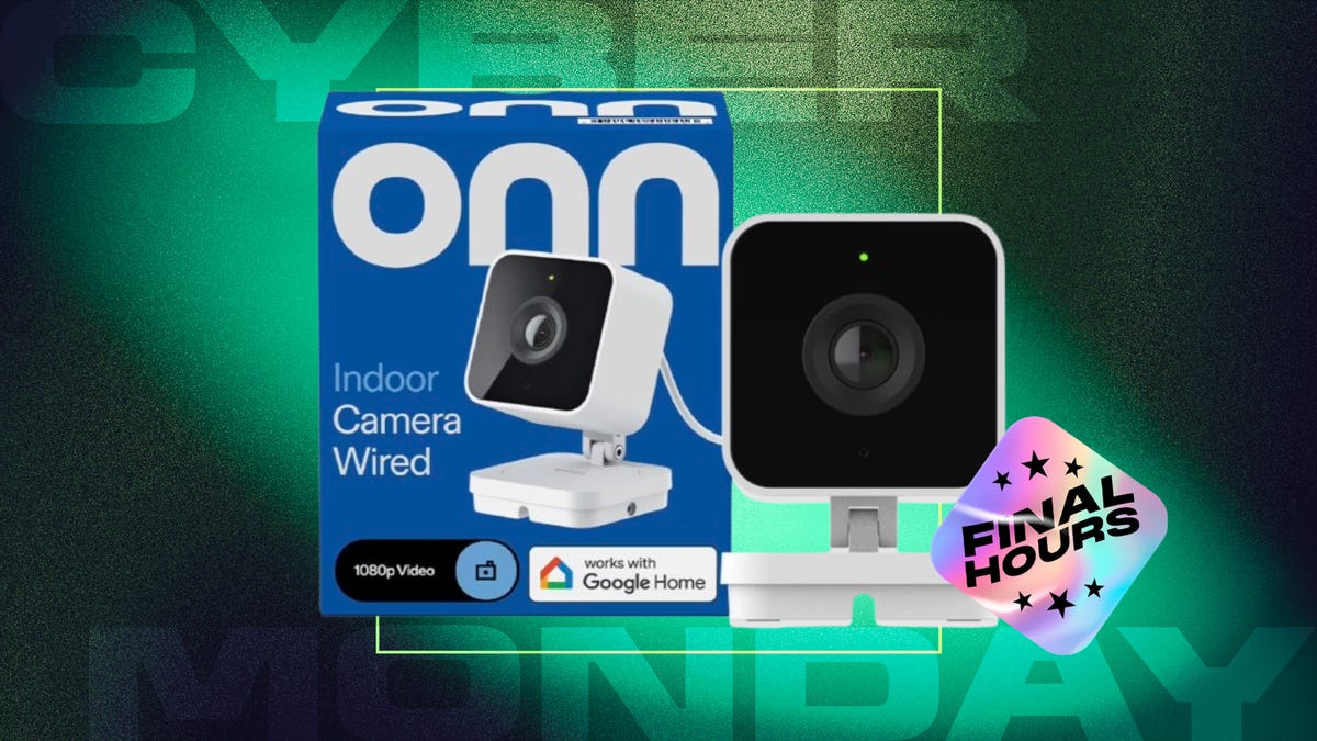 From left: blue box, white indoor camera with black square lens cover against green and dark green/black CNET background.