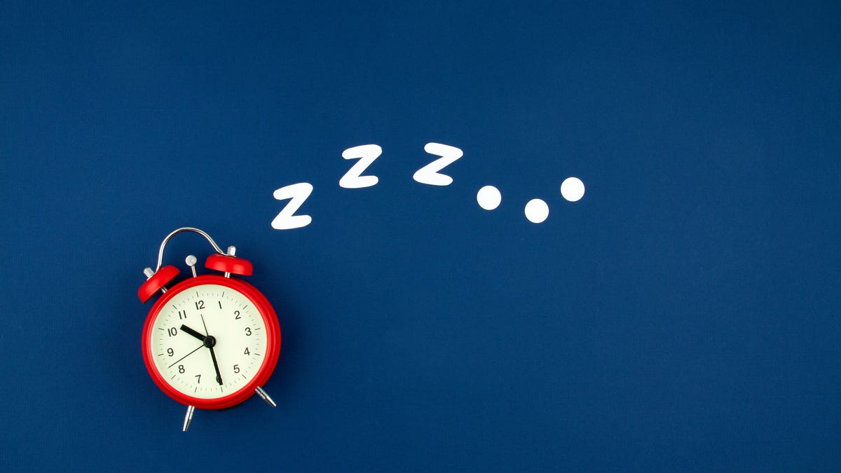 An alarm clock against a navy blue backround