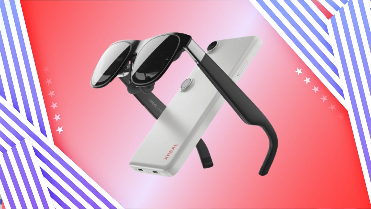 Xreal One Pro AR Glasses with Beam Pro controller against red gradient background