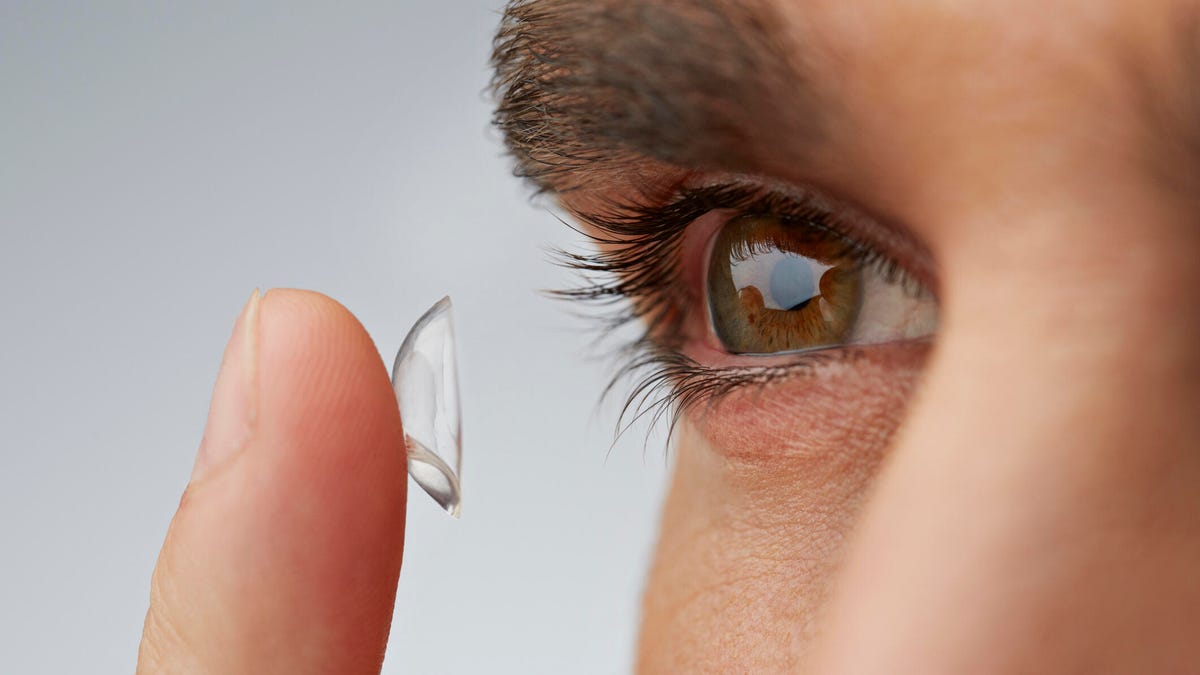 Close up of man putting in contact lens