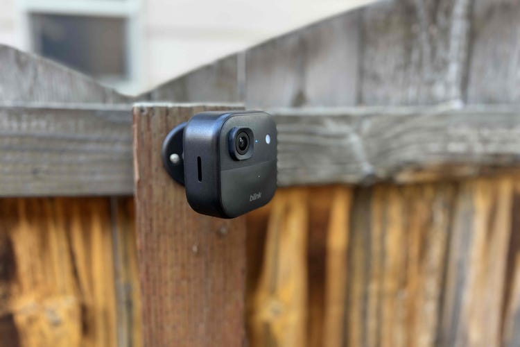 A Blink Outdoor 2K camera mounted to a wood fence.