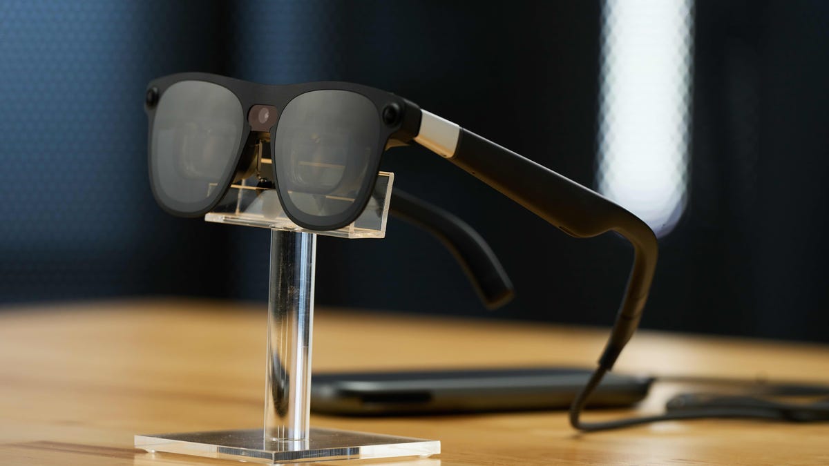Xreal Project Aura glasses on a pedestal, tethered to a processor puck