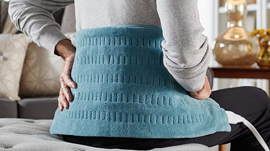 Green heating pad on a mans back