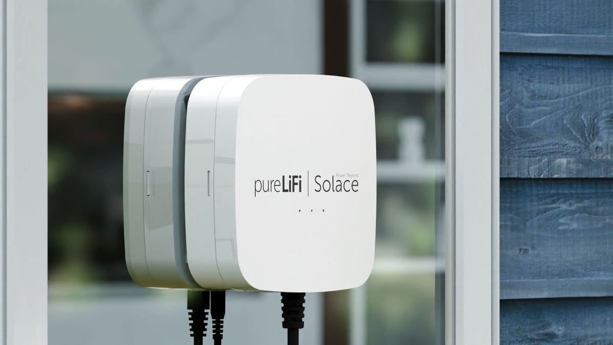 white box attached to a window with logo: pureLiFi | Solace