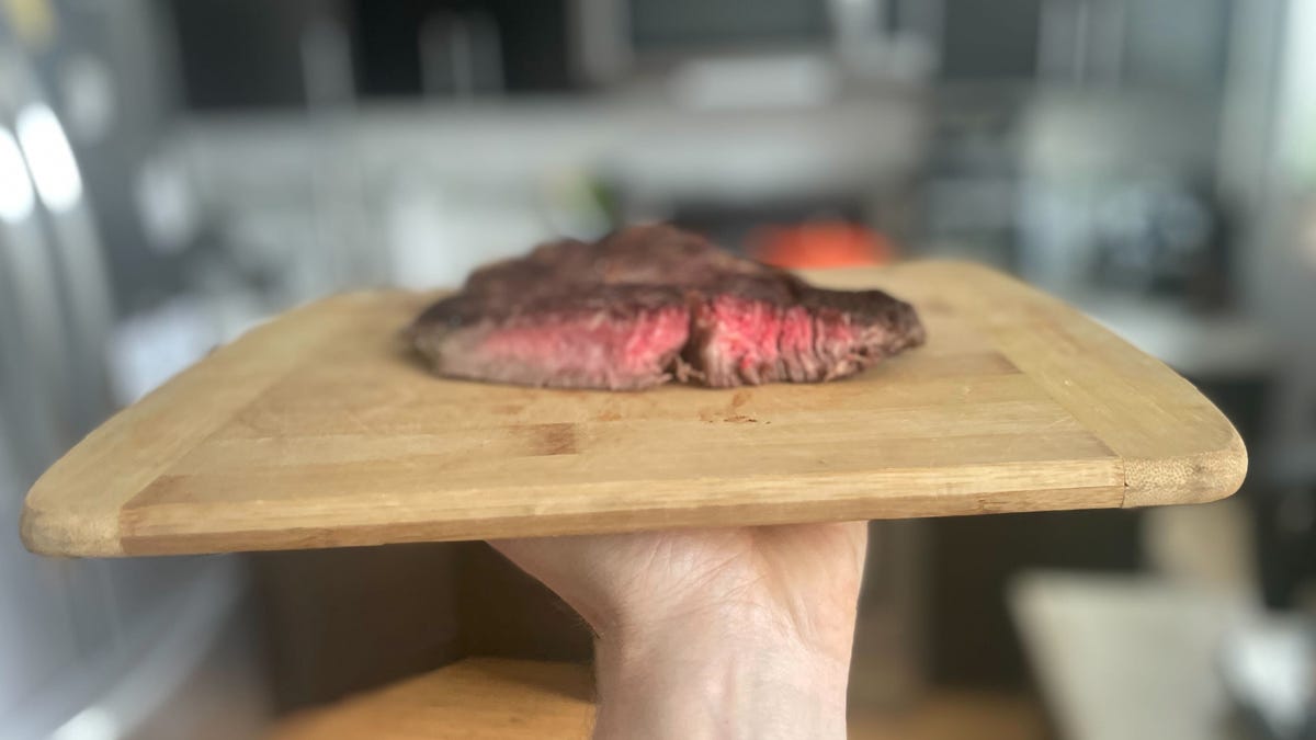 Medium rare steak on cutting board