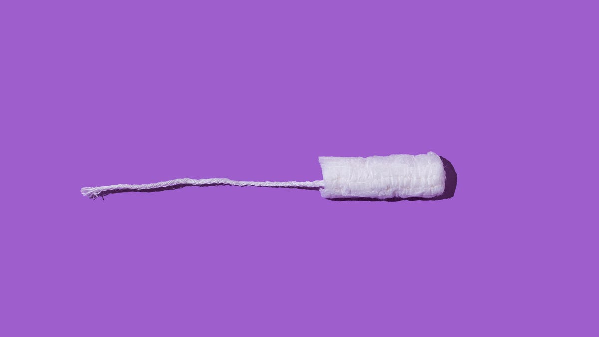 A tampon against a purple background