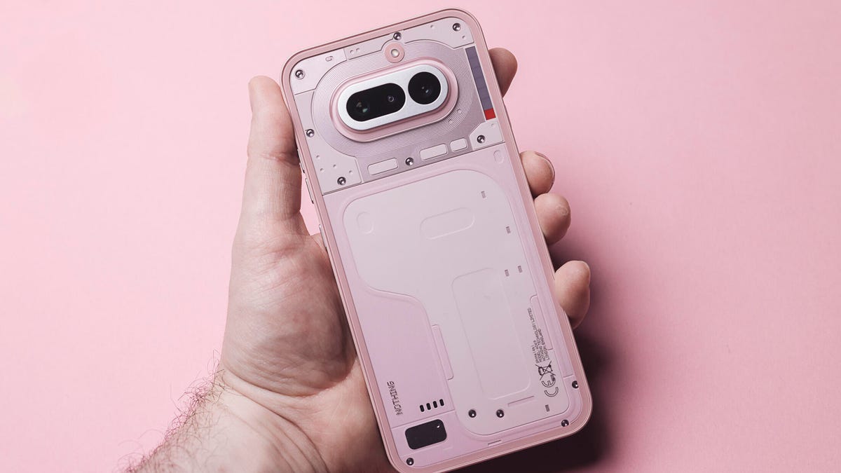 Image of a pink phone being held in the hand