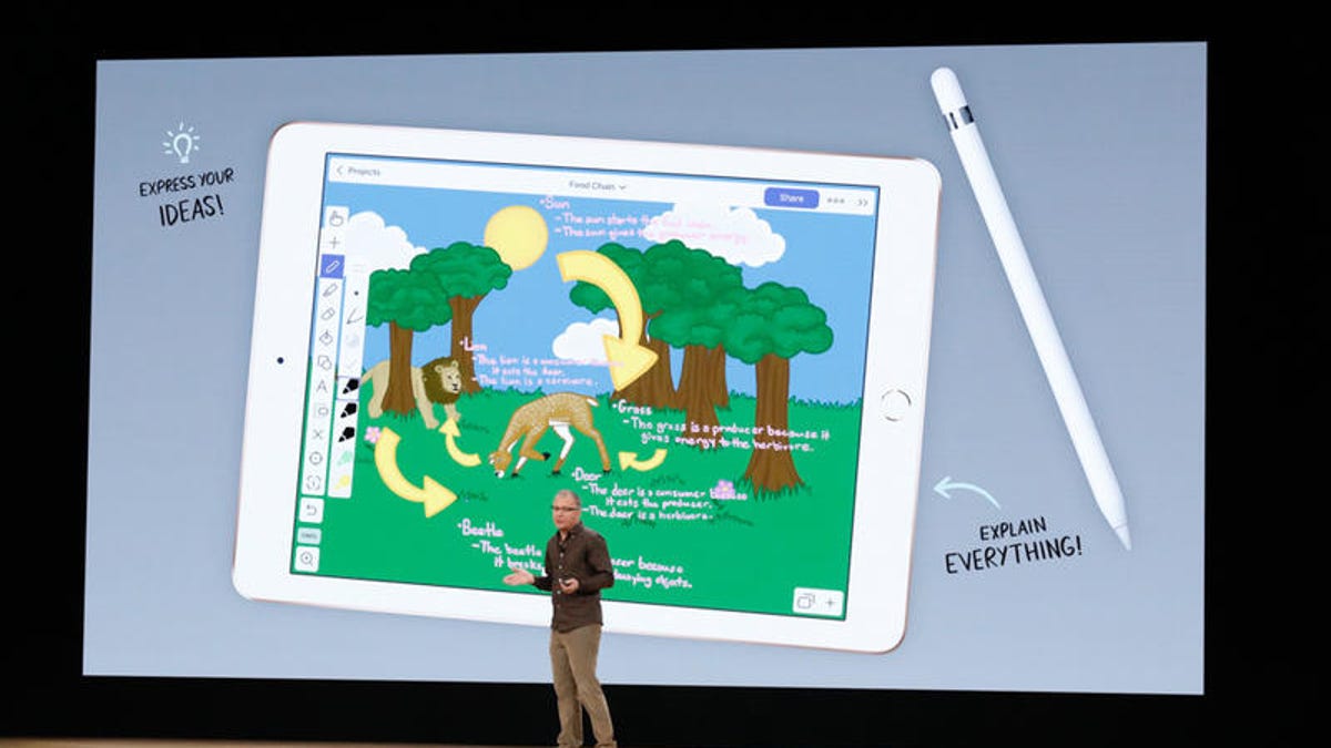 Apple's Tim Cook in front of a large rendering of the new iPad and Apple Pencil.