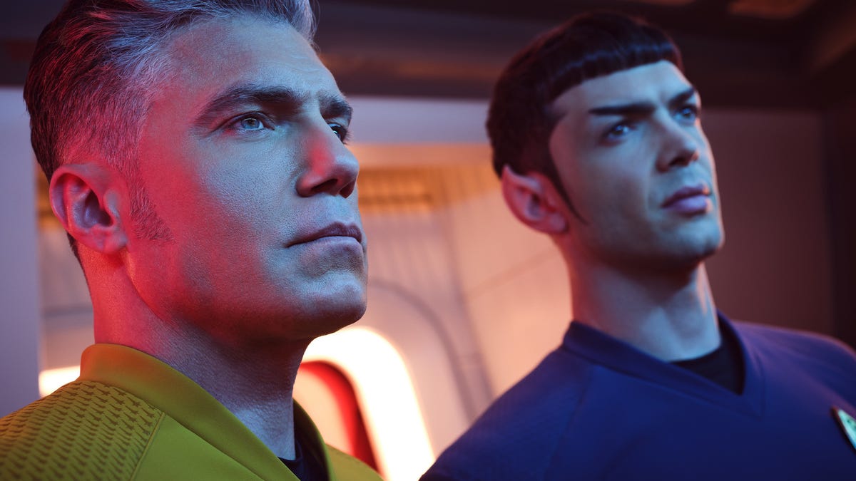 Captain Pike and sexy young Spock look ahead in atmospheric lighting on the bridge of the Enterprise in Star Trek: Strange New Worlds.