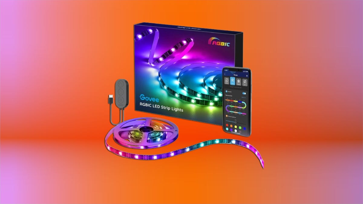 Govee smart light bulbs in different lamps showing orange, magenta, and turquoise colors in a home