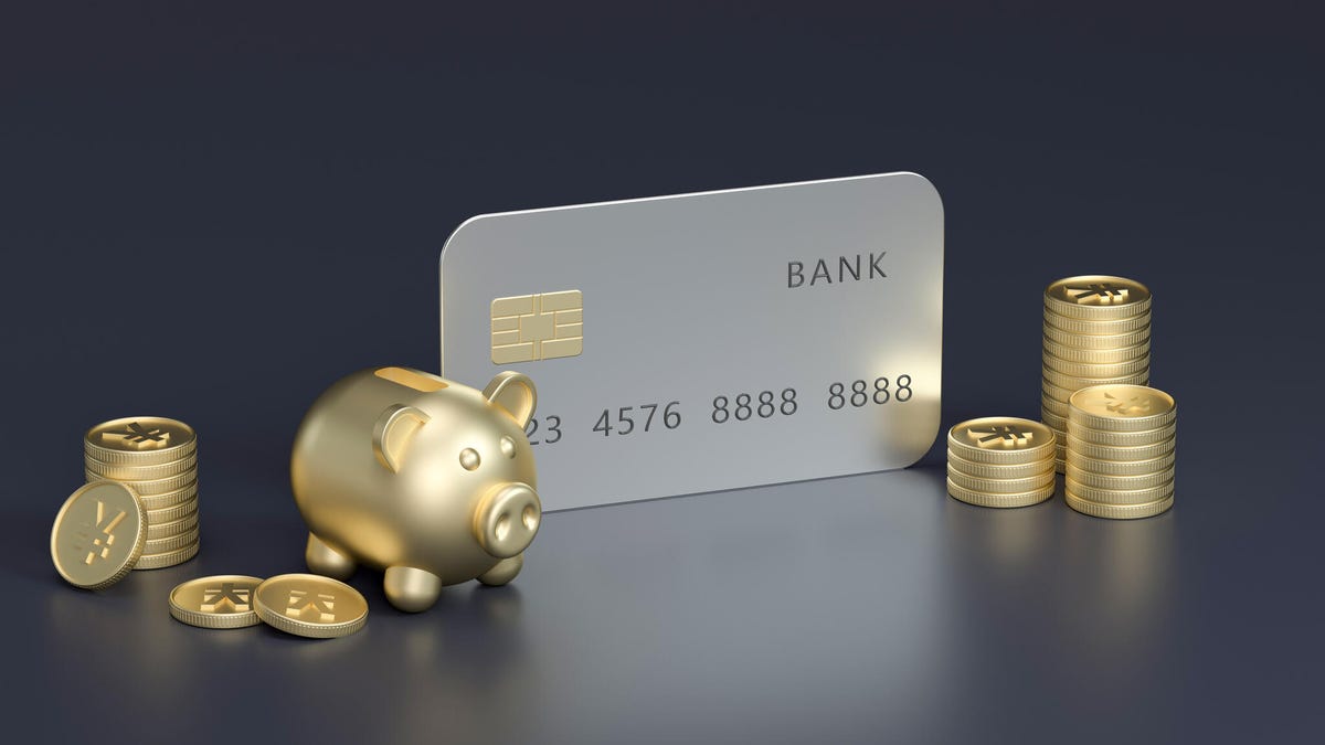 The metal Business Platinum card rests against a blue wall.