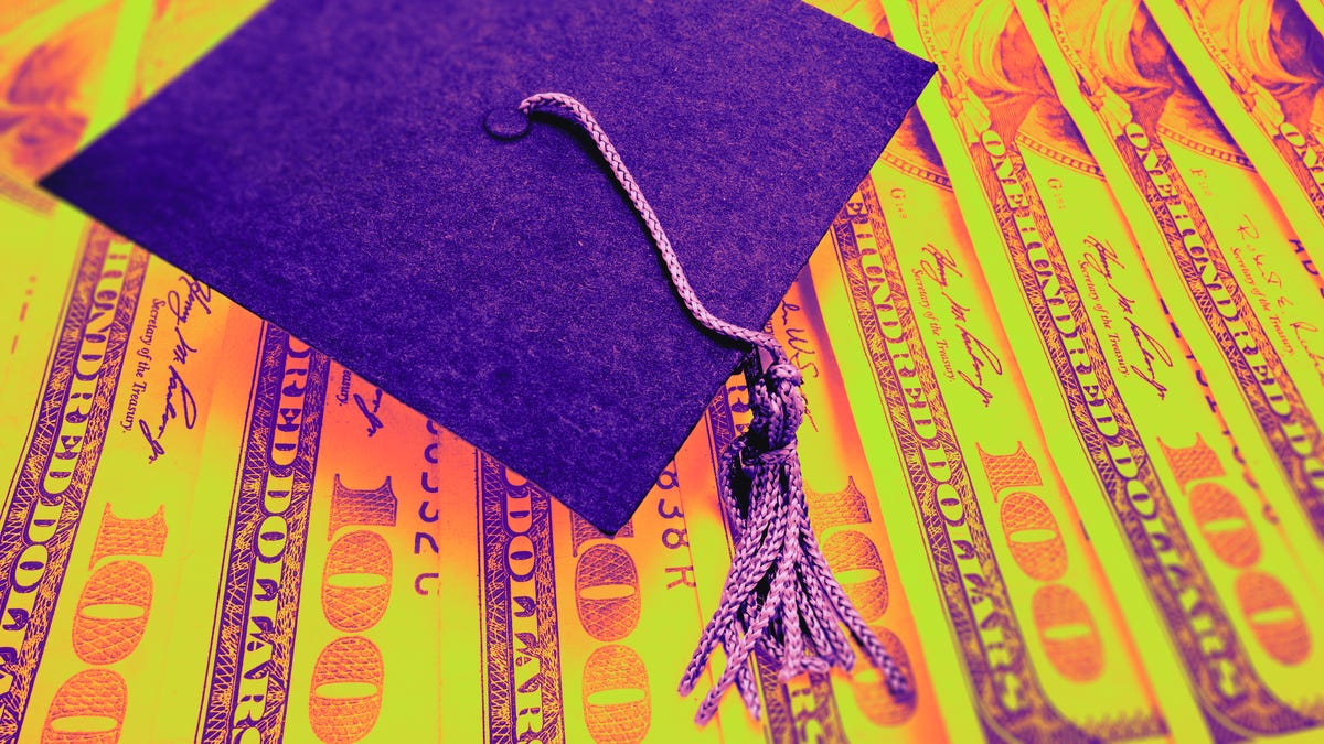 graduation cap on dollar bills