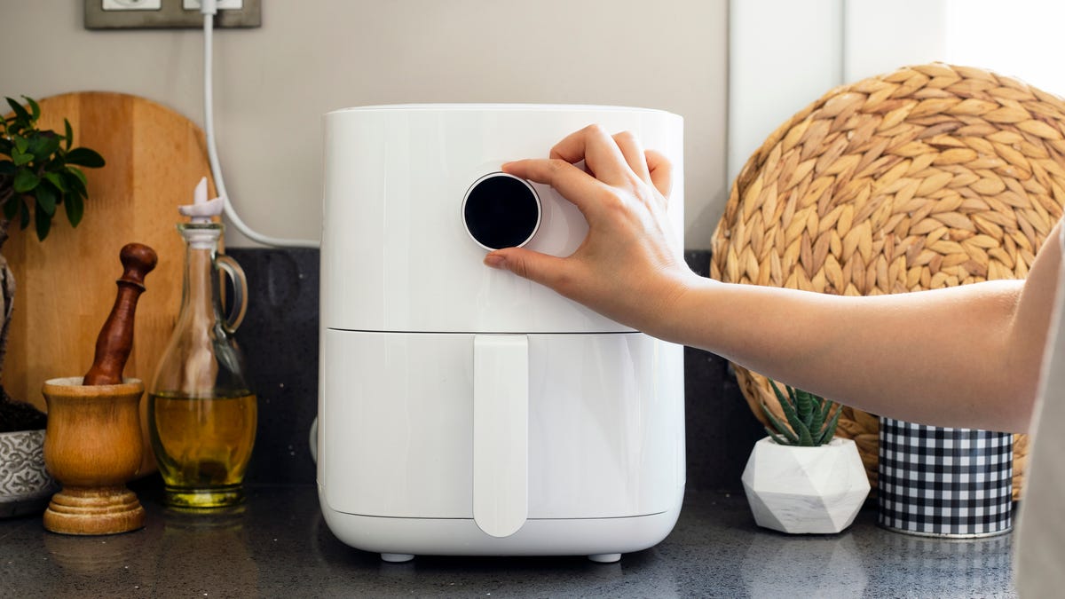 air fryer on counter being turned on