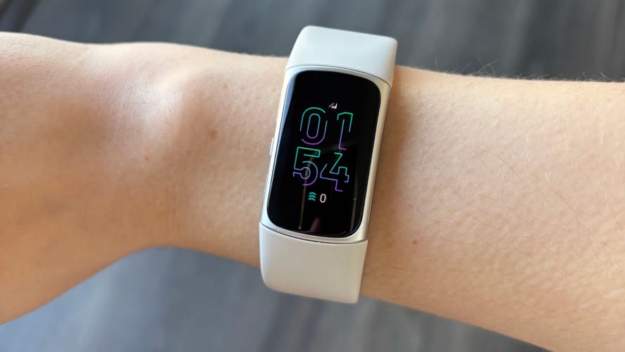 The Fitbit Charge 6 on a wrist showing the time.