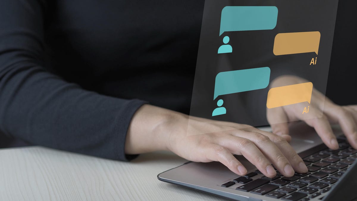 A person's hands type on a laptop keyboard with chat bubbles for a conversation with an AI superimposed above.