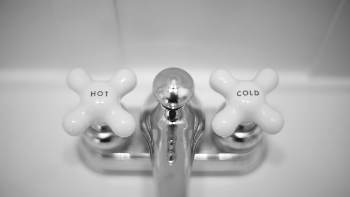 Hot and cold knobs on a faucet.