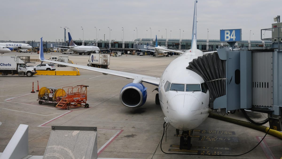 A United plane waiting at a gate.
