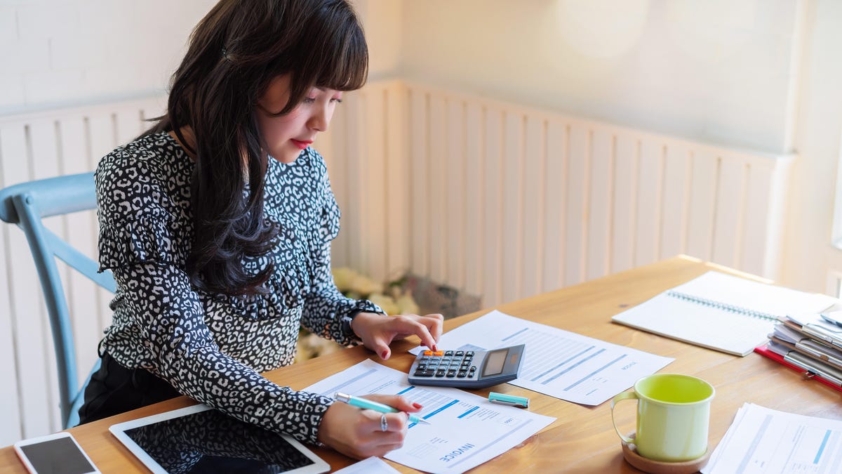 A woman doing taxes at a table.
