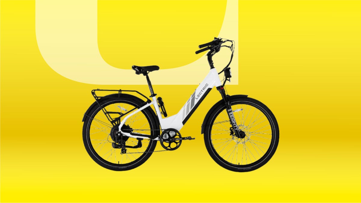 White Lectric e-bike with black wheels and accents against yellow CNET background.