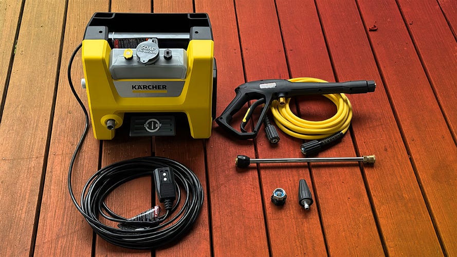 The Karcher pressure washer with its hoses and nozzles.