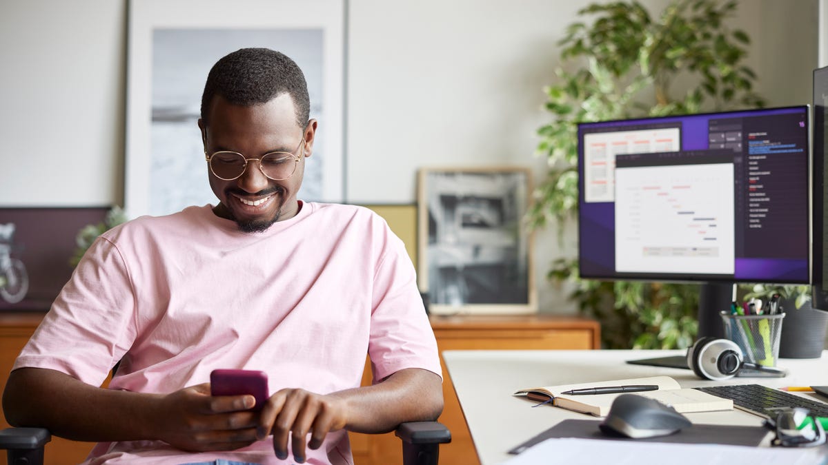 Man scrolling on his phone.