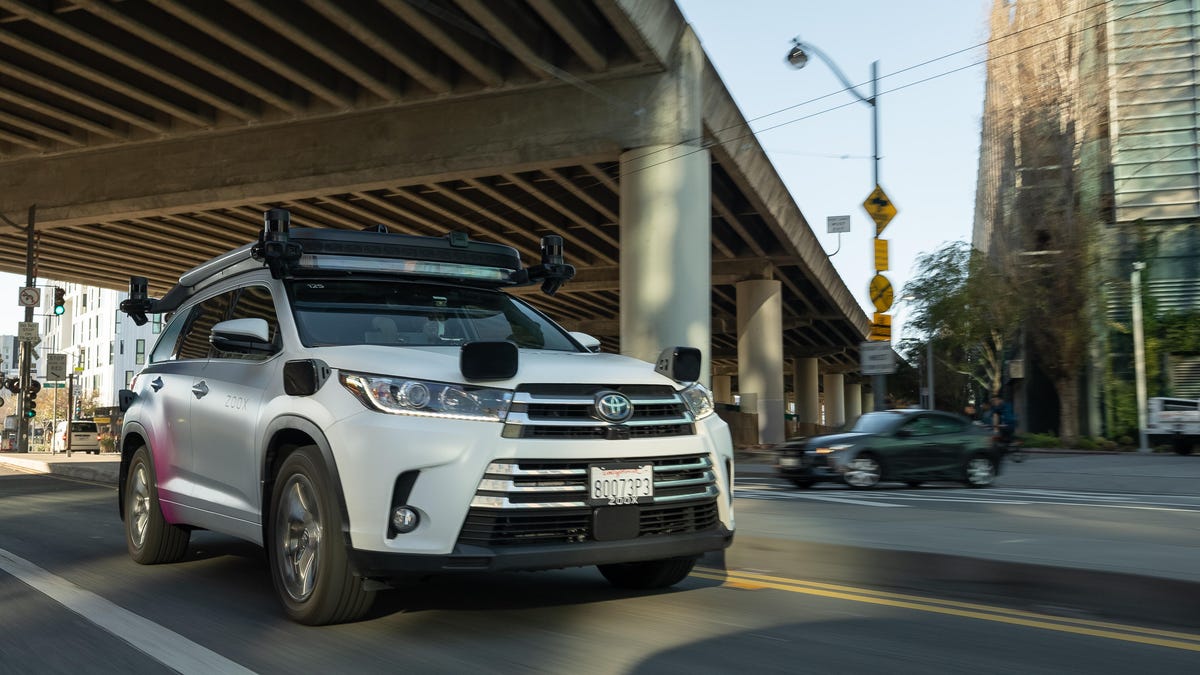 A Zoox retrofitted Toyota Highlander on the road in Washington, DC, mounted with lidar, radar and cameras