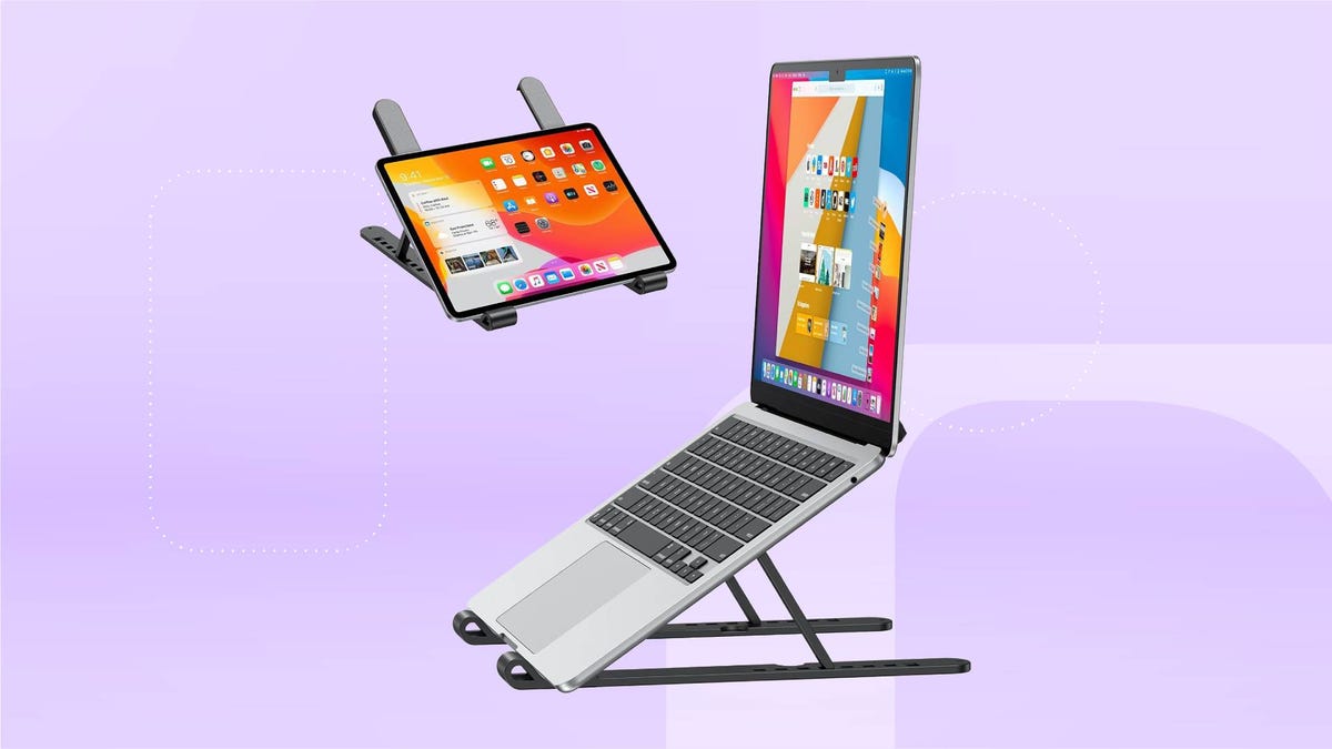 A laptop and tablet in a black stand against a lavender gradient CNET background.