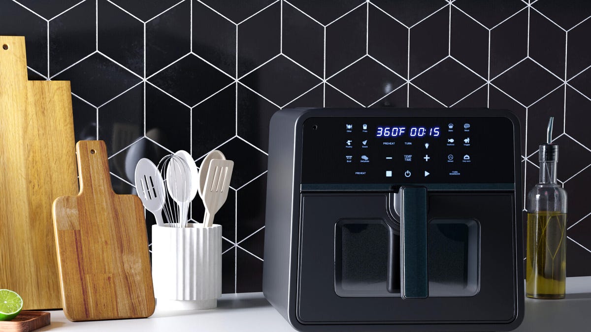 A black Emerson Smart air fryer on a white counter.
