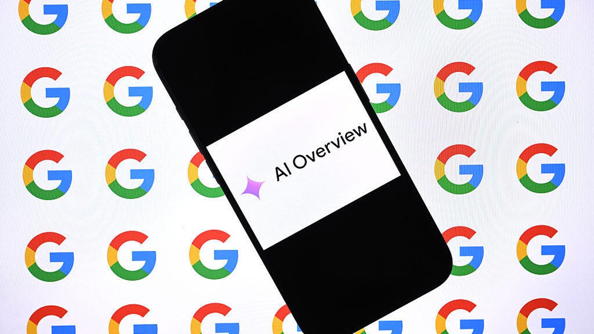 A cellphone with an image on it that reads AI Overview. The AI sparkle precedes the words.