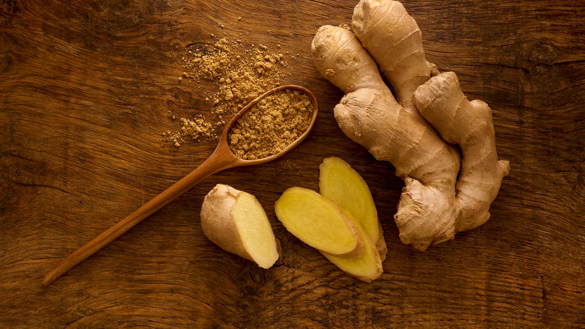 Ground and fresh ginger on a wooden table