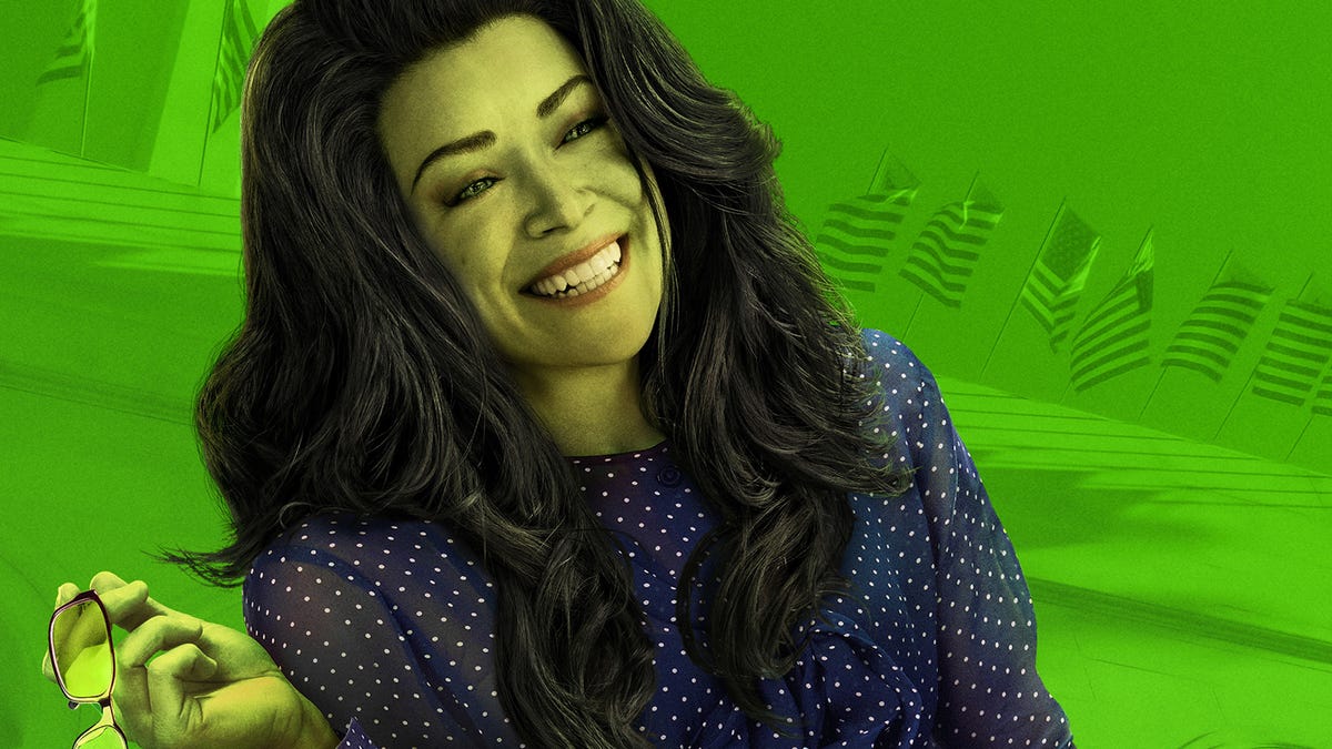 She-Hulk smiles and holds her glasses casually in one hand