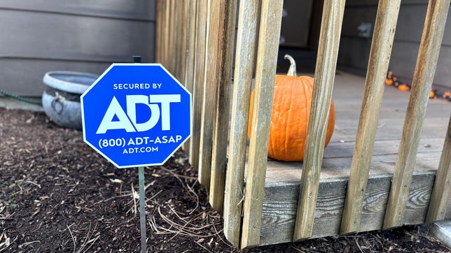 ADT sign in front yard in fall.