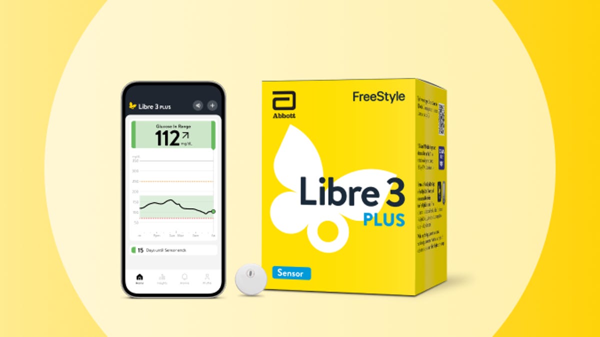 A cell phone displaying the FreeStyle Libre app is next to a Libre 3 Plus box. A Free Style Libre Plus sensor sits between them.