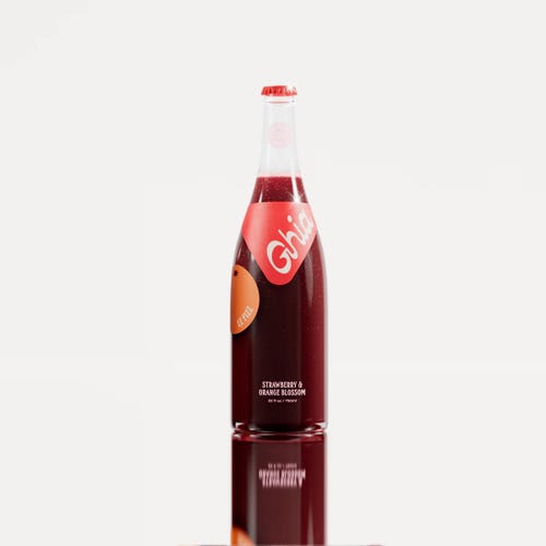 A bottle of the Ghia Le Fizz aperitif in front of a white background.