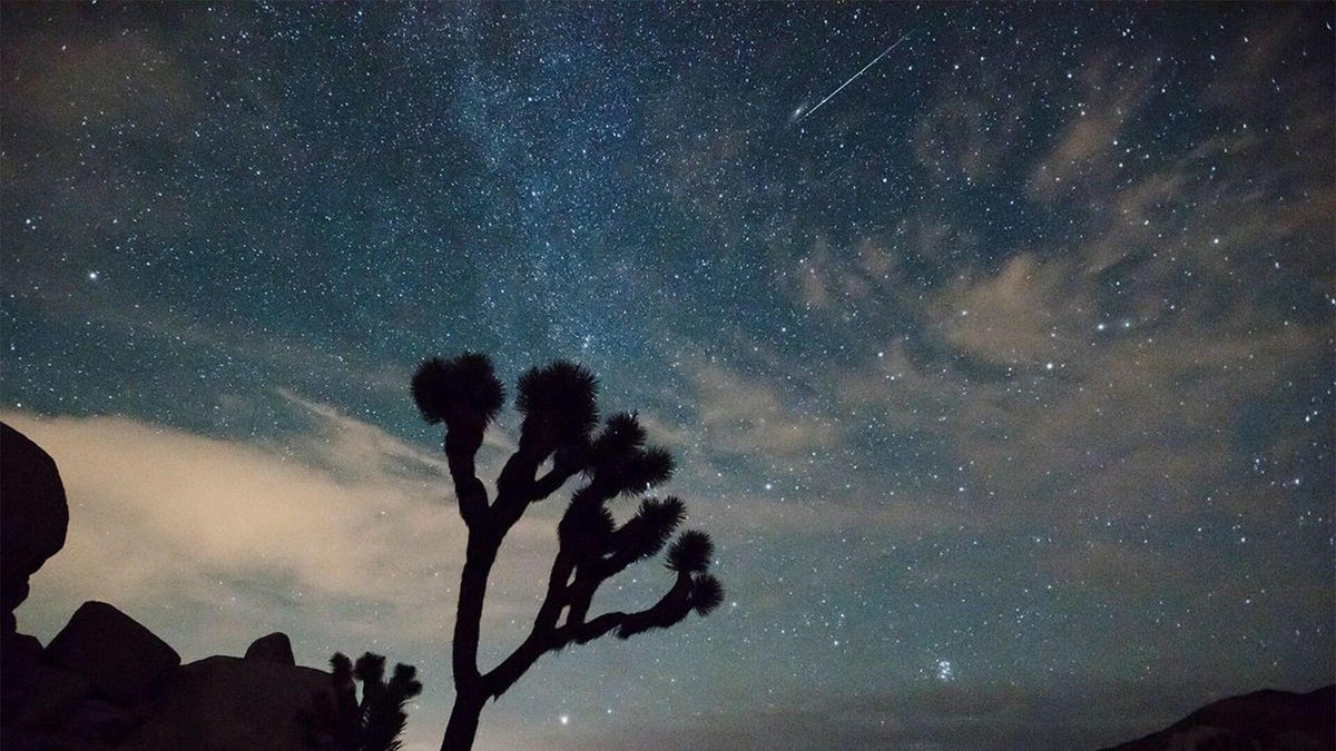 A lone meteor seen in the sky over a desert