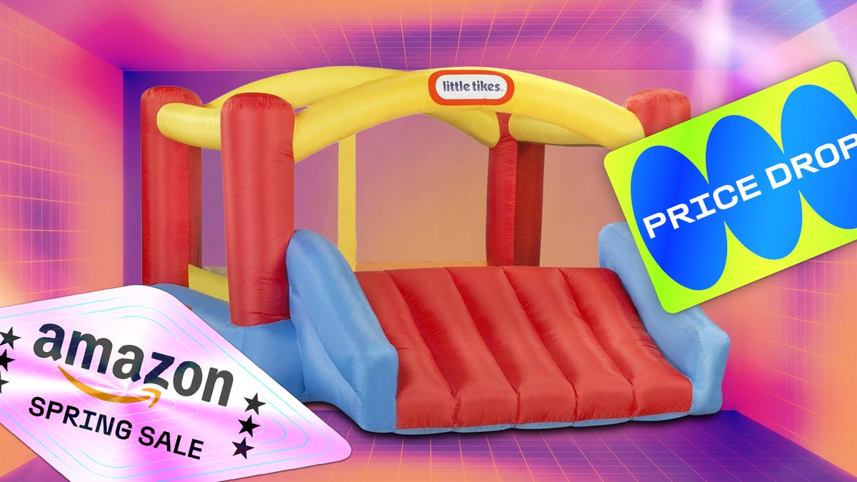 Colorful inflatable bounce house with slide and mesh sides for safe backyard play on CNET background