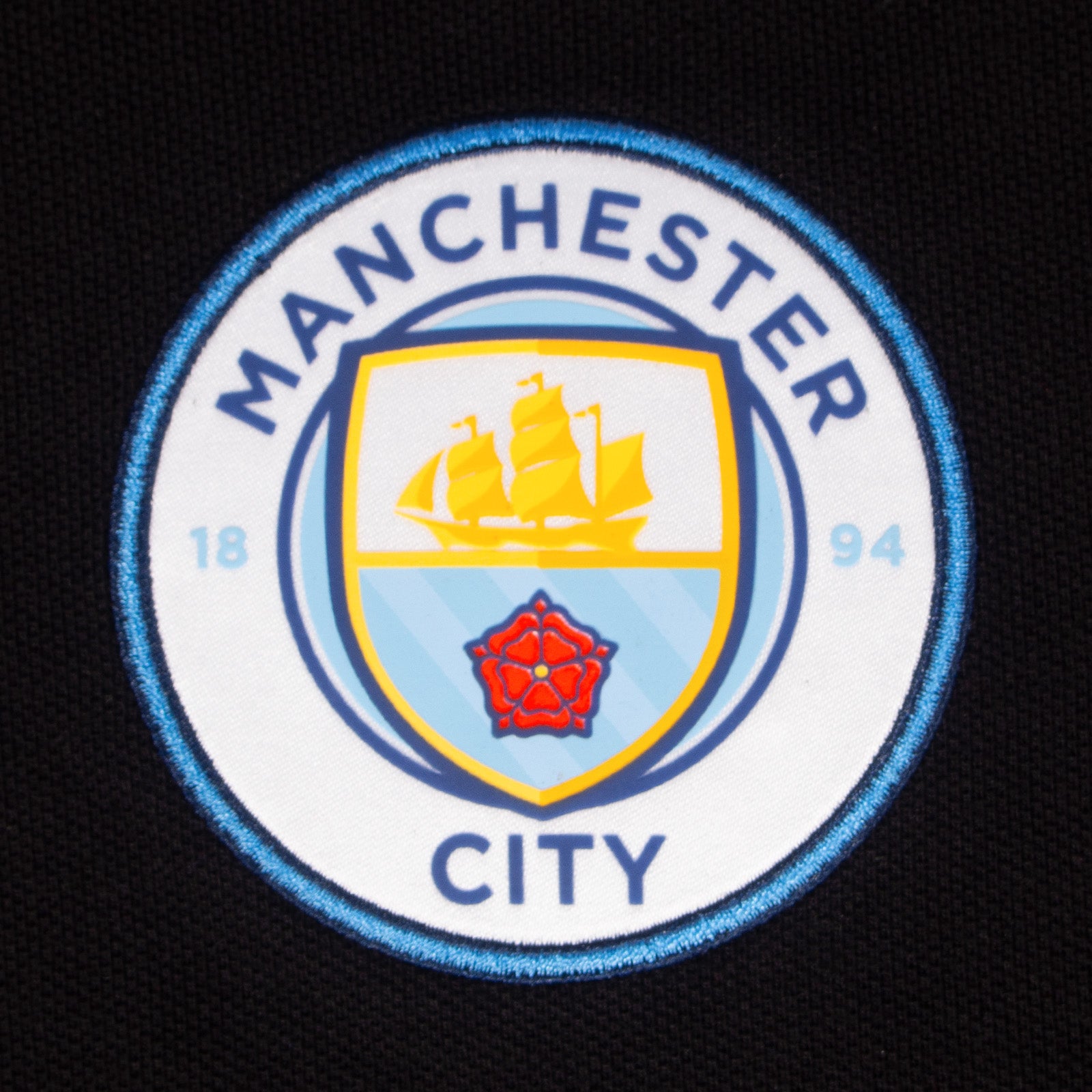 Man City adults polo shirt in black with club crest to the chest.