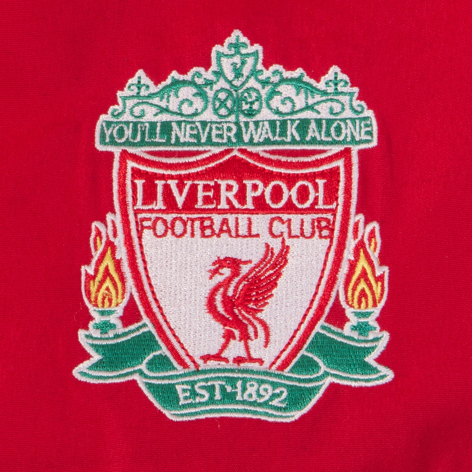 Liverpool kids tracksuit in red with club crest to chest and left thigh