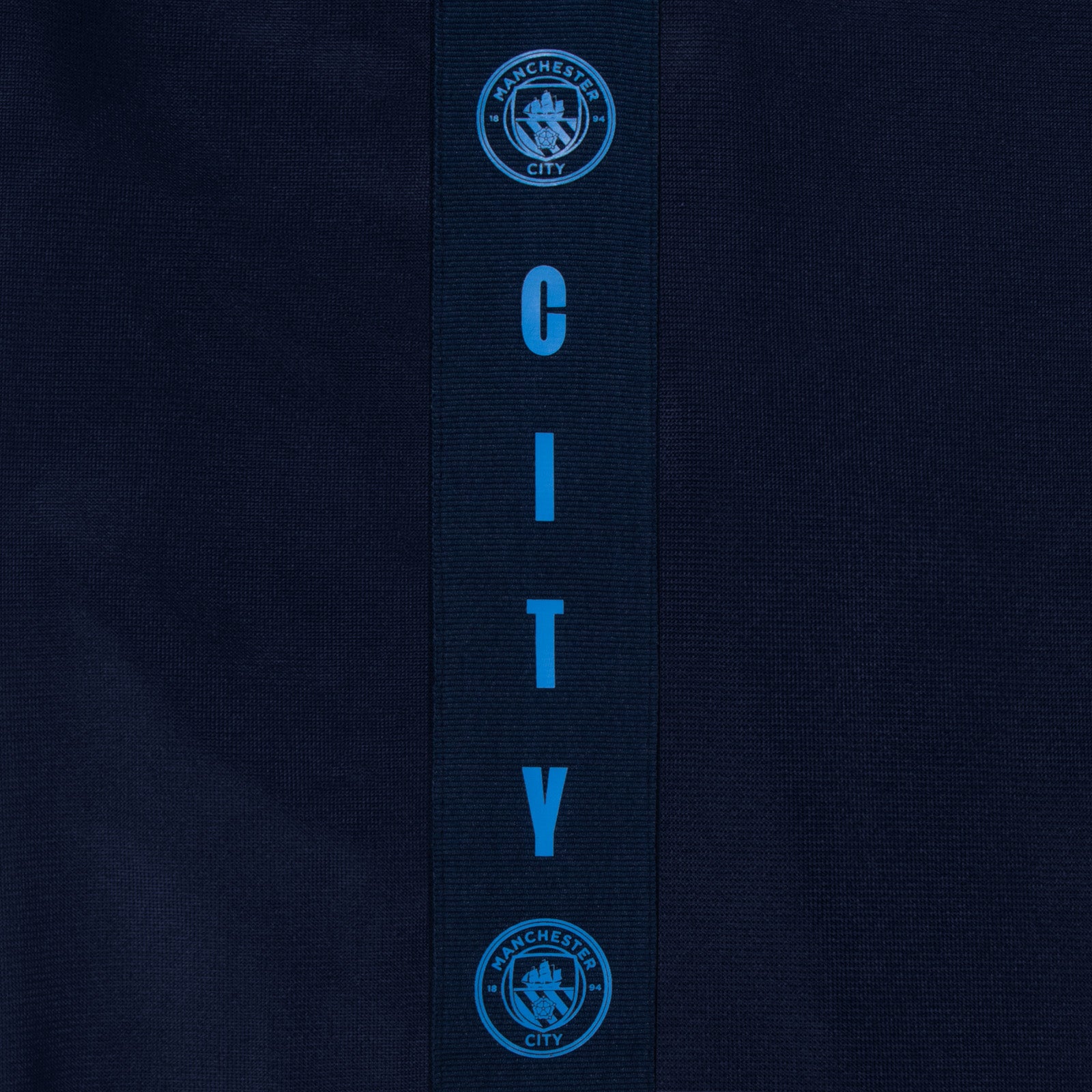 Manchester City adults taped tracksuit in navy blue with club crest and text to both top & pants