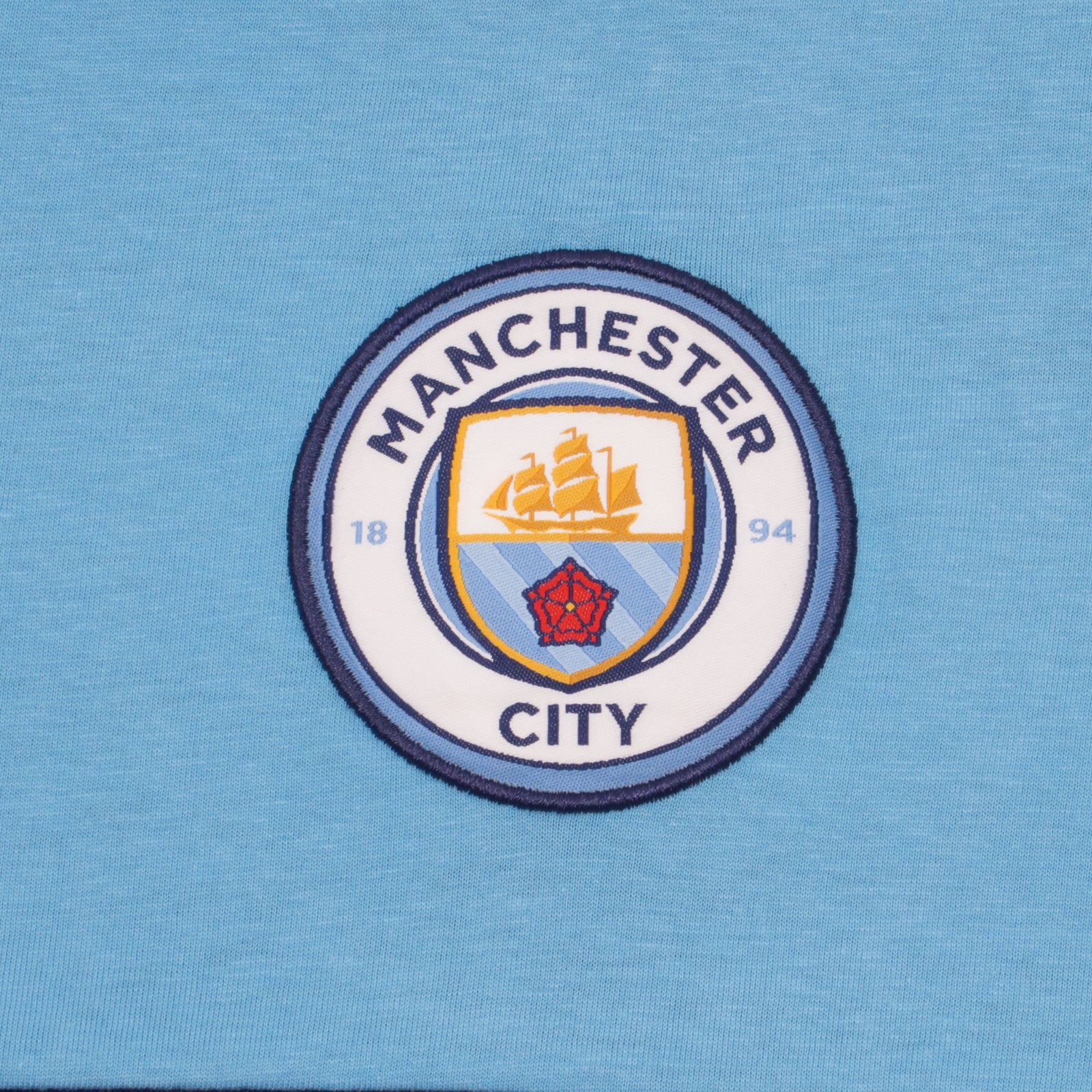 Man City adults long pyjamas in navy & sky blue. Two-tone short sleeve top with crest and long bottoms with badge